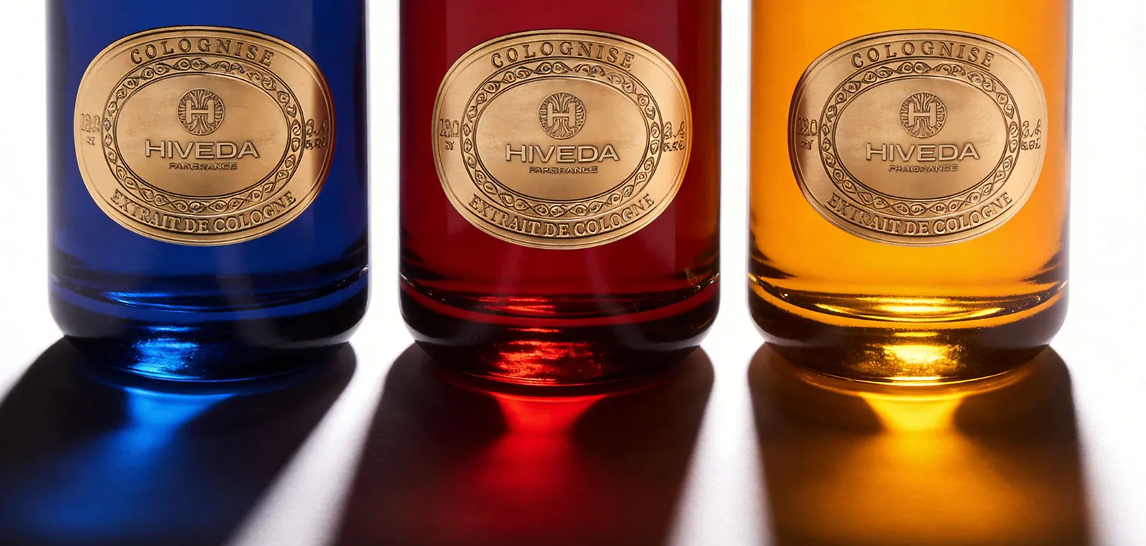 perfume bottles in blue burgundy and amber color directions