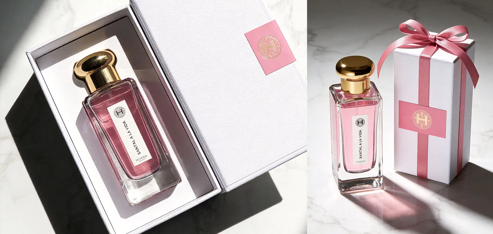 pink perfume bottle with white presentation box and ribbon