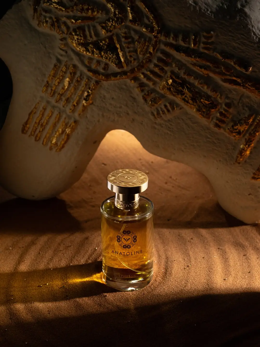 ANATOLINE Ephesus perfume bottle photographed with warm archaeological-style props