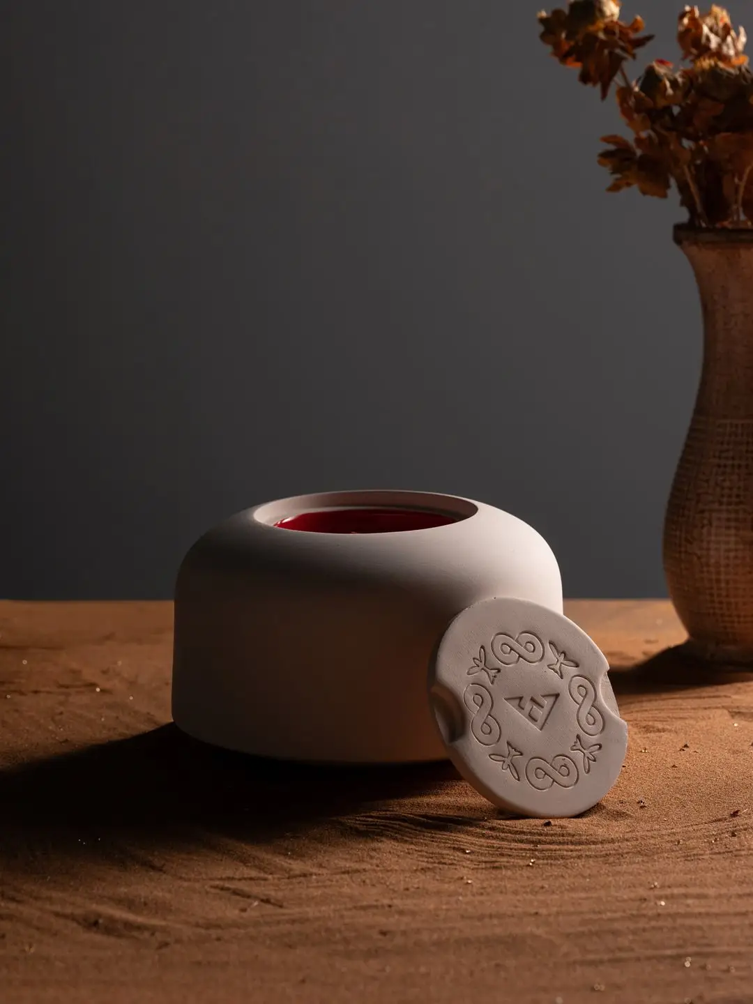Pale rounded ANATOLINE Temple Collection vessel with a decorated circular element beside it